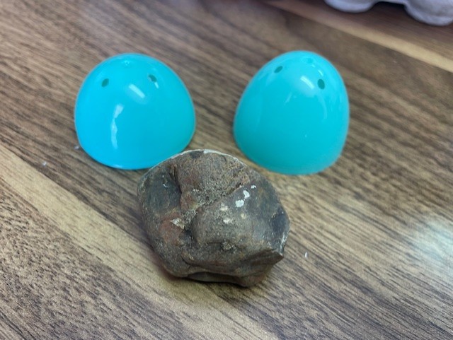 A small stone — symbol of the stone sealing the tomb